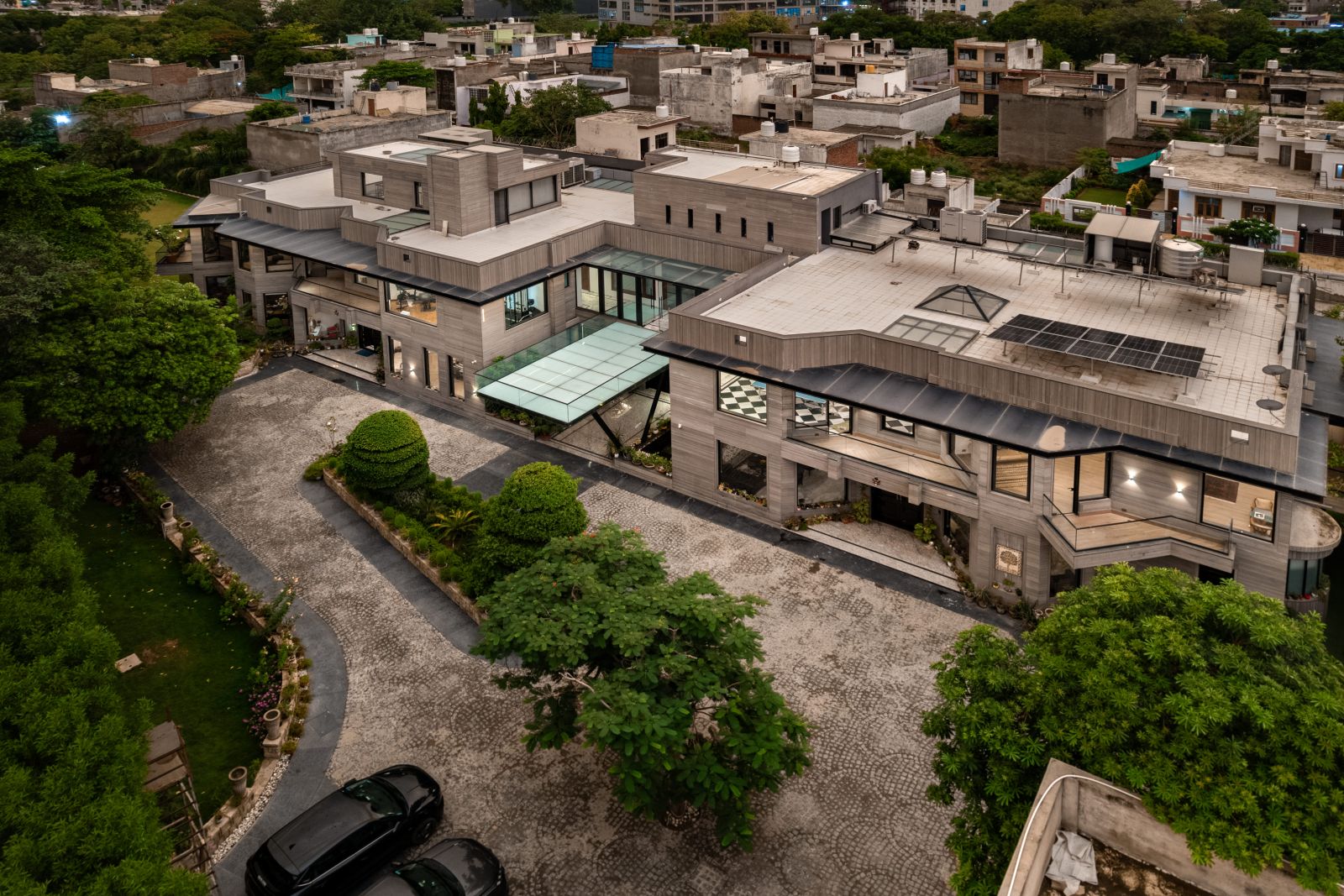 Wide elevated view of the twin residence, landscaped central grounds and interconnected architectural wings